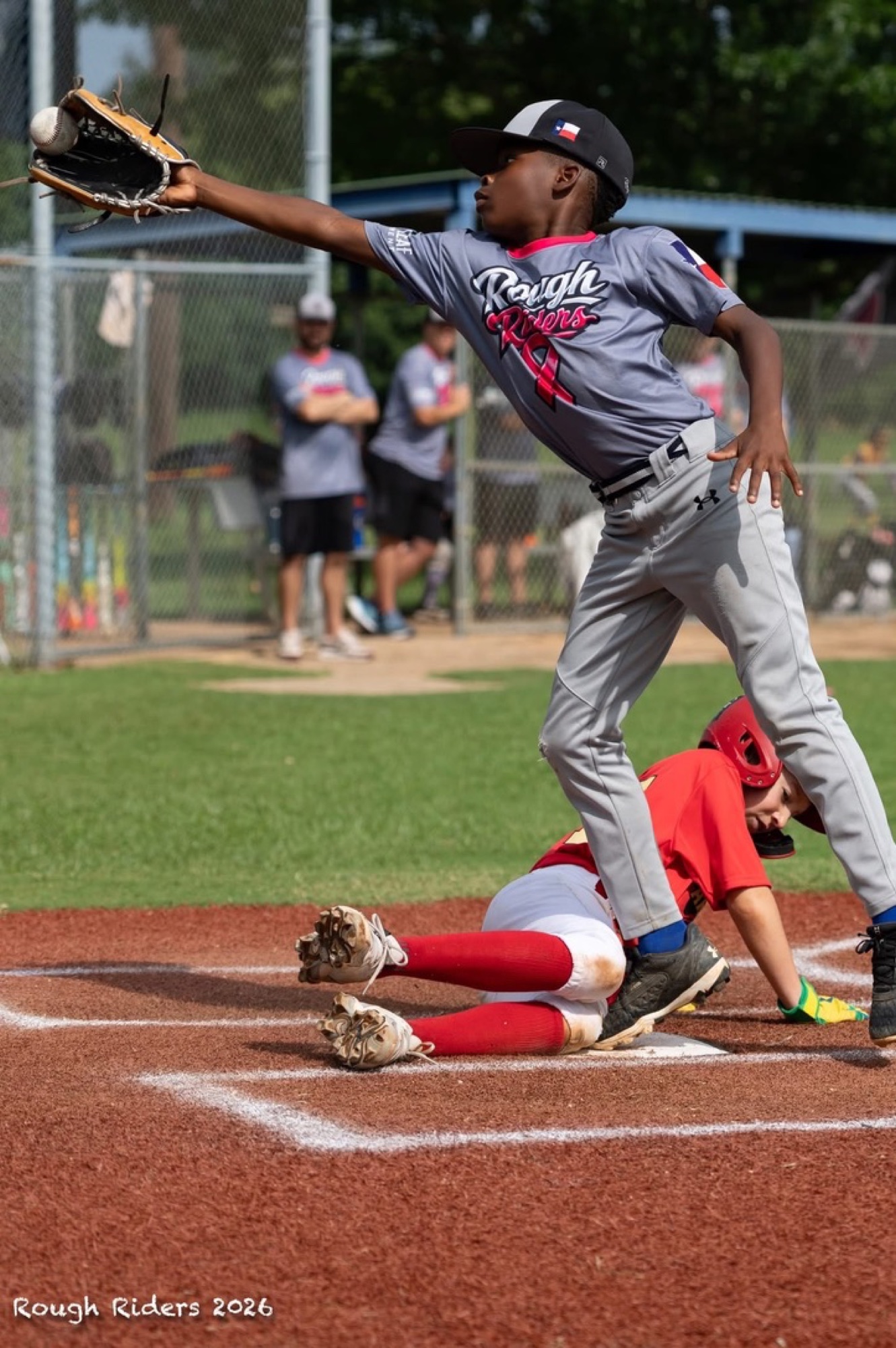 Rough Riders baseball player making a stretch play at first base