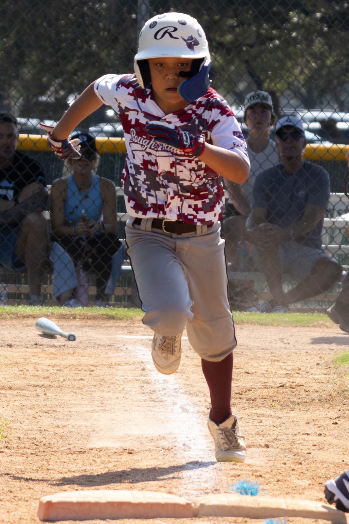 Rough Riders baseball player sprinting toward home plate