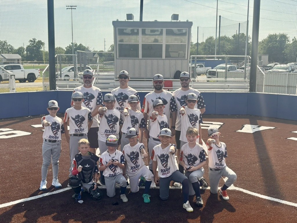 Rough Rider Youth baseball team and coaches together on the field